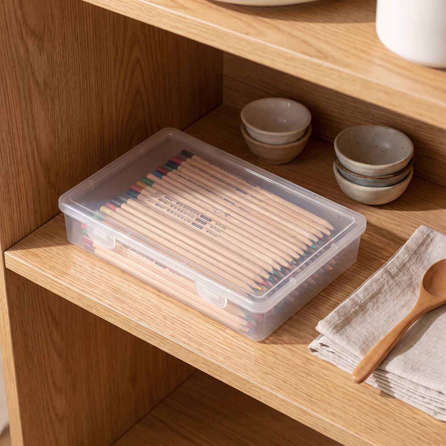 Top view of a clear desktop organizer filled with pencils