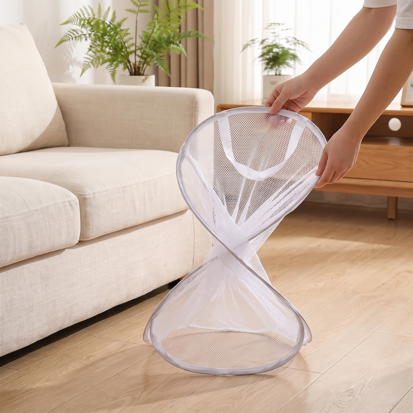 Hands folding the white mesh storage basket